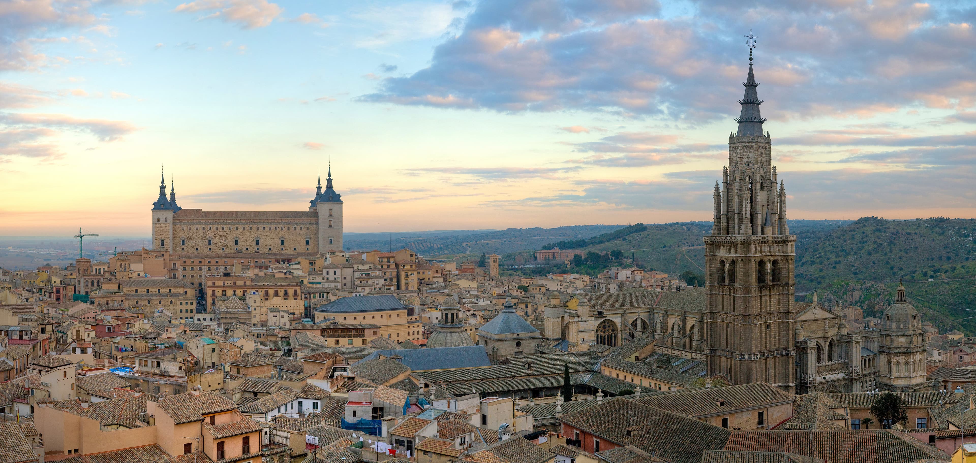 Toledo at sunrise: the Alcázar on the left, the cathedral tower on the right