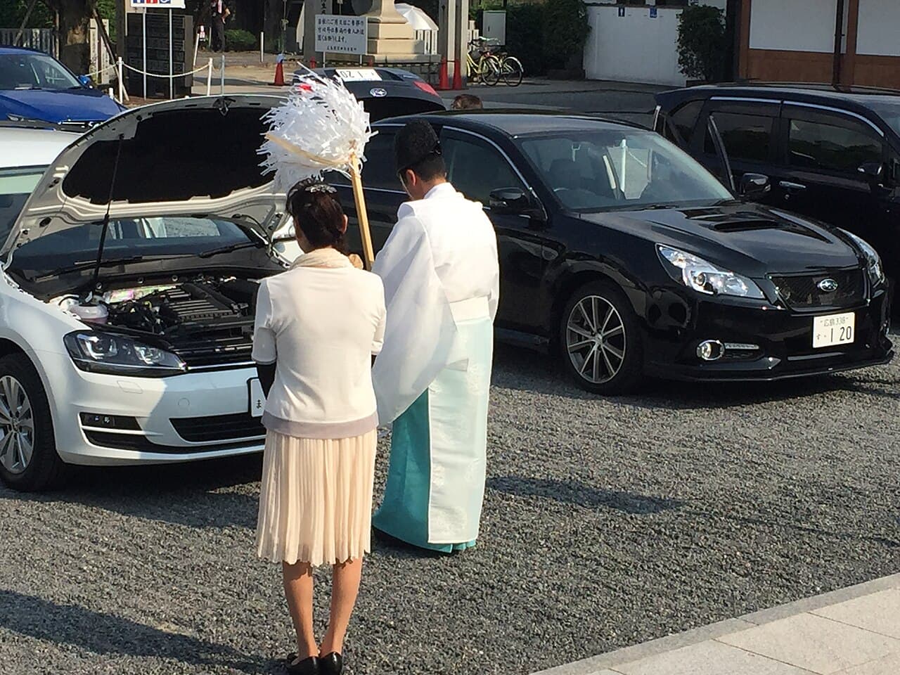 Shinto priest performing a purification rite with an onusa wand