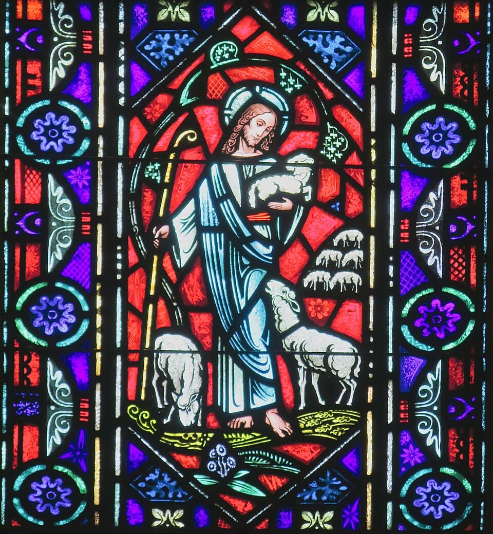 Good Shepherd stained-glass window depicting Christ carrying a sheep