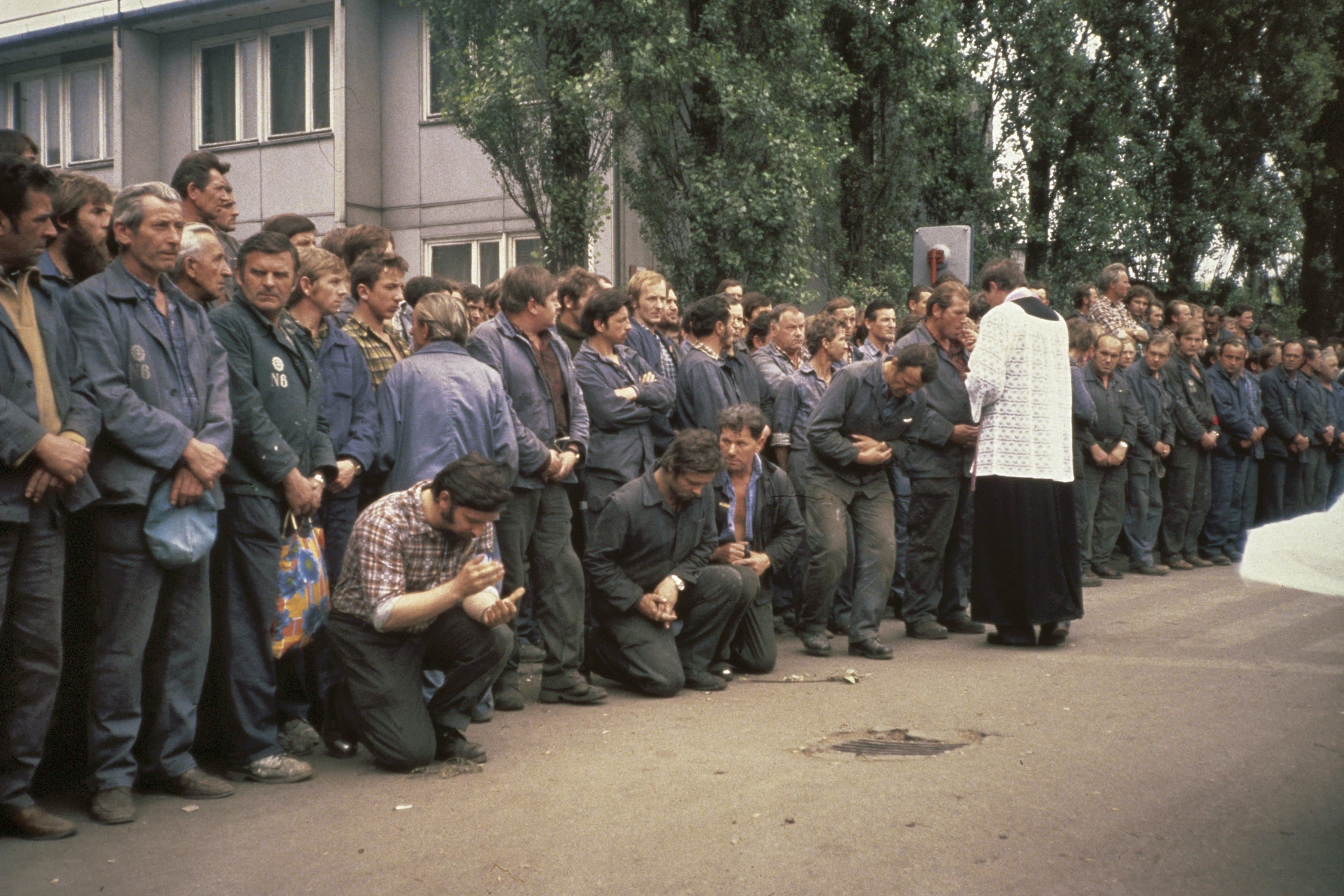 Striking workers receive communion during an open-air Mass at the Gdansk shipyards on 20 August 1980