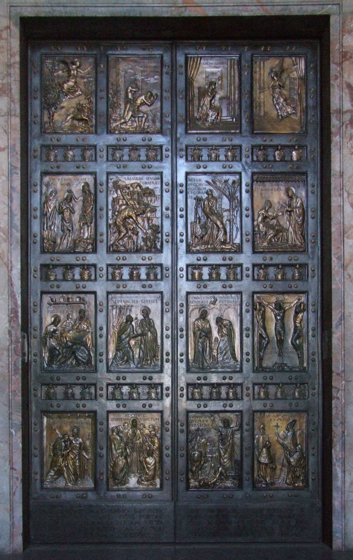 The closed Holy Door of Saint Peter's Basilica, decorated with reliefs by Vico Consorti