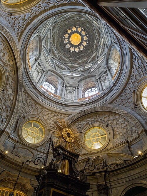 Low-angle view of the tiered arches and luminous openings of Guarini's dome