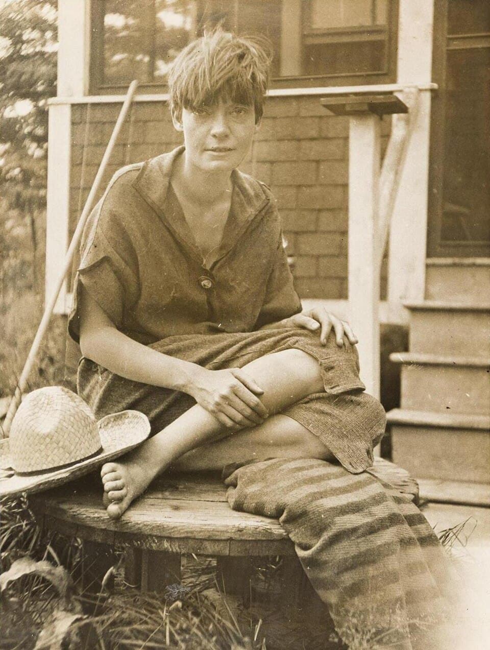 Dorothy Day seated in front of her Staten Island bungalow